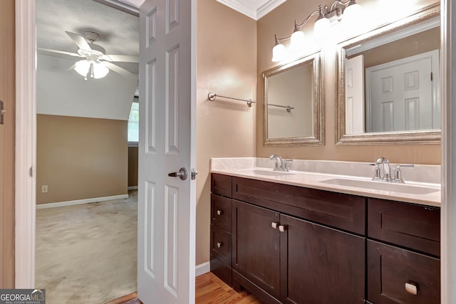 bathroom featuring ceiling fan, vanity, crown molding, and a textured ceiling