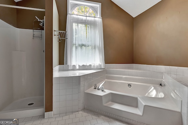 bathroom with vaulted ceiling, separate shower and tub, and tile patterned floors