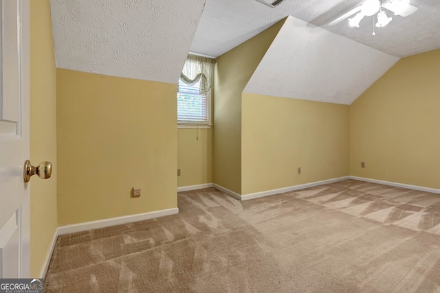 bonus room featuring vaulted ceiling, a textured ceiling, and carpet floors