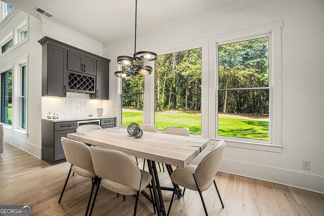 dining room featuring ornamental molding and light hardwood / wood-style floors