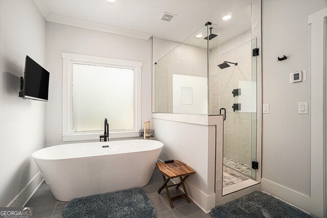 bathroom featuring shower with separate bathtub and tile patterned flooring