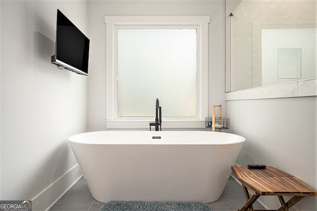 bathroom featuring tile patterned flooring and a bathing tub