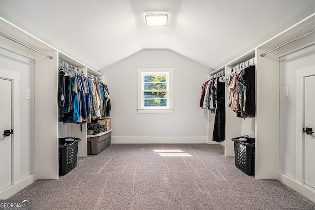 spacious closet featuring vaulted ceiling and carpet