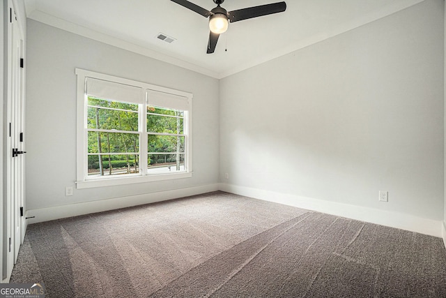 carpeted spare room featuring ceiling fan and ornamental molding