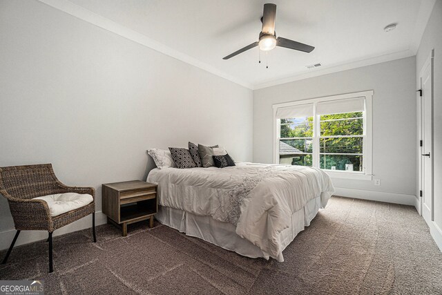 bedroom with ornamental molding, dark carpet, and ceiling fan