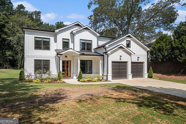 modern farmhouse style home with a garage and a front lawn