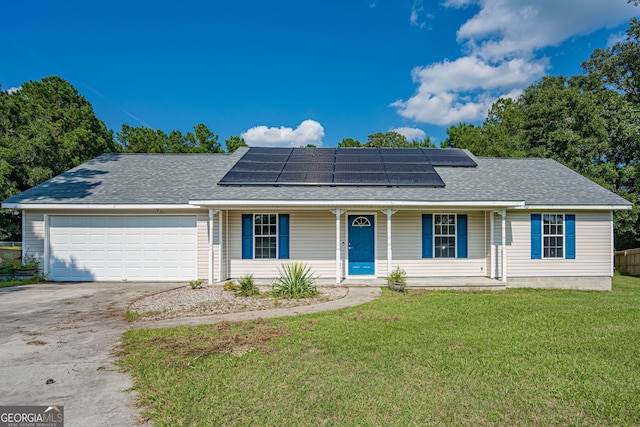 ranch-style house with a front lawn, solar panels, and a garage