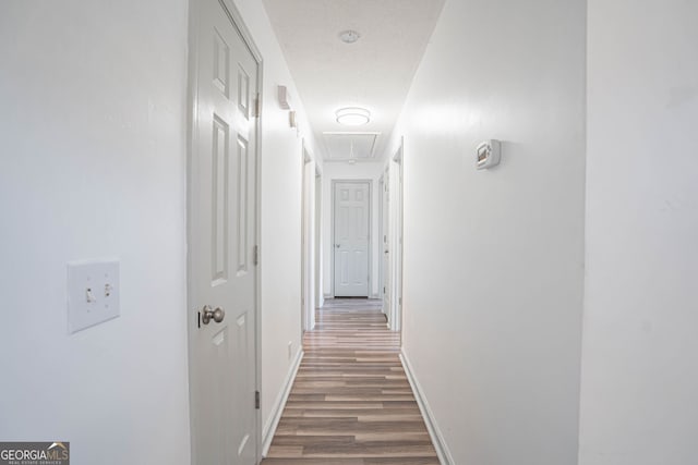 hallway with dark hardwood / wood-style floors