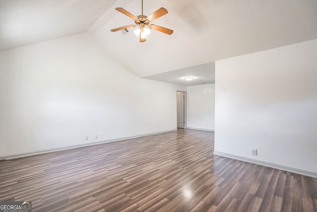 empty room featuring ceiling fan, vaulted ceiling, and dark wood-type flooring