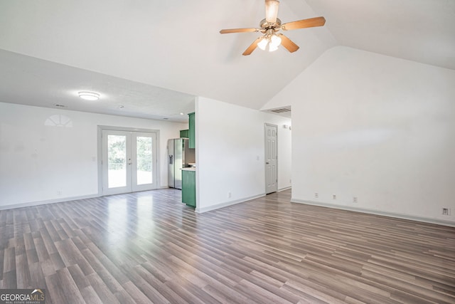 unfurnished living room featuring a textured ceiling, high vaulted ceiling, hardwood / wood-style floors, ceiling fan, and french doors