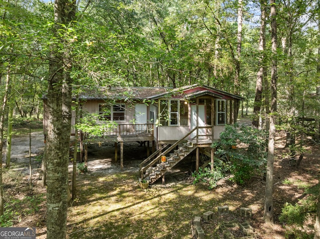 rear view of house with a wooden deck