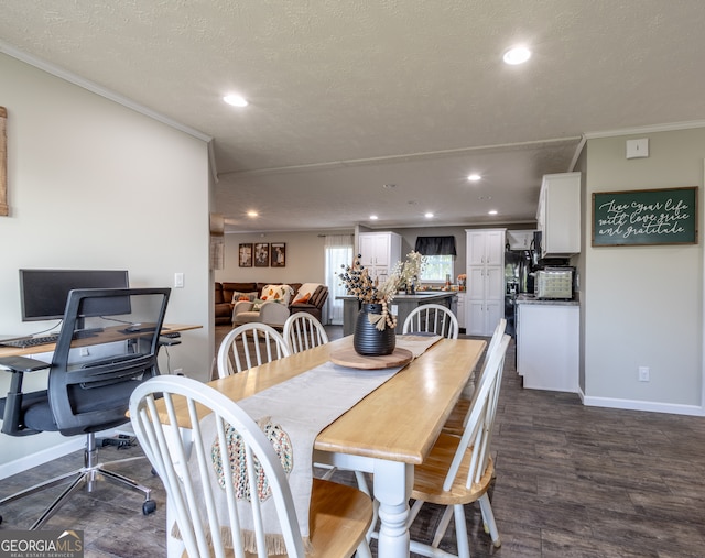 dining area with a textured ceiling, crown molding, and dark hardwood / wood-style floors