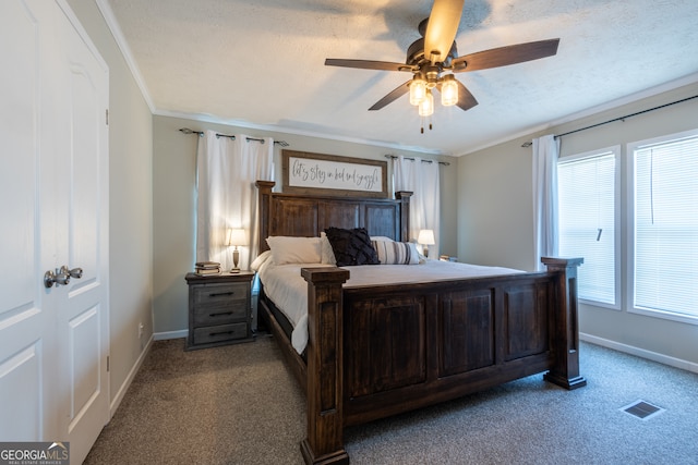 bedroom with a textured ceiling, ornamental molding, light carpet, and ceiling fan