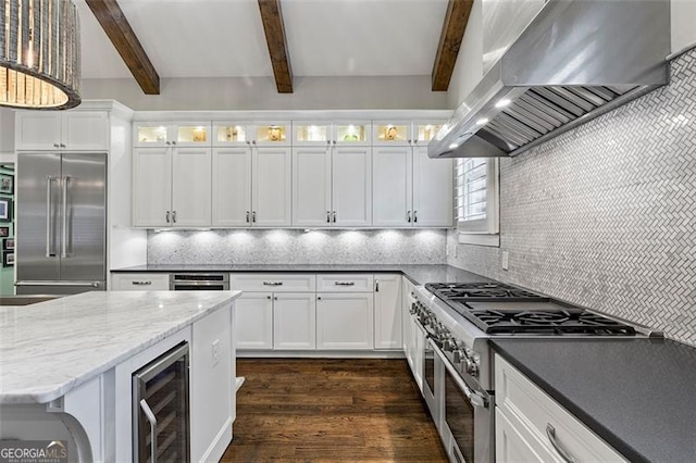 kitchen featuring wall chimney exhaust hood, white cabinets, and wine cooler