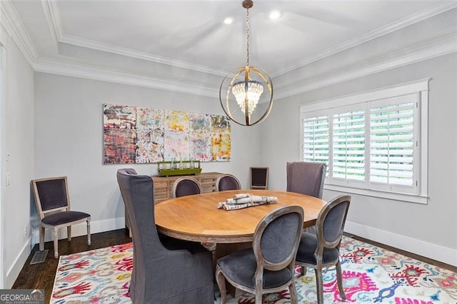 dining area featuring ornamental molding, a chandelier, and dark wood-type flooring