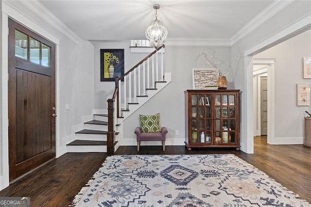 entryway featuring crown molding, a chandelier, and dark hardwood / wood-style flooring