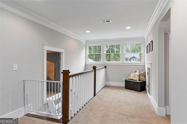 hallway featuring light colored carpet and crown molding