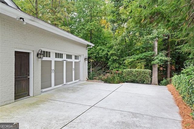 view of patio / terrace with an outdoor structure and a garage