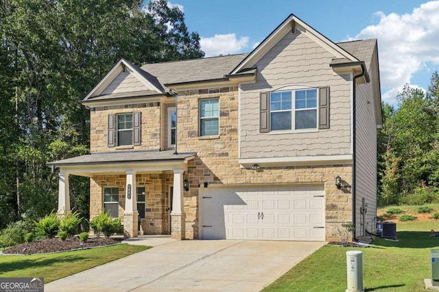 craftsman house featuring a garage, a front lawn, and central air condition unit