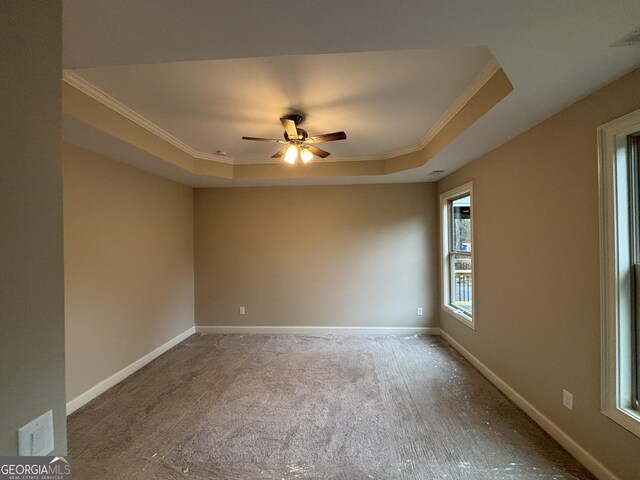 5544 Whispering Swan Ct, Douglasville, GA 30135 - empty room featuring a raised ceiling, ornamental molding, carpet, a ceiling fan, and baseboards