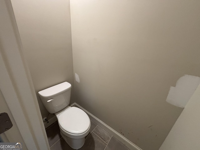 bathroom with tile patterned flooring and toilet