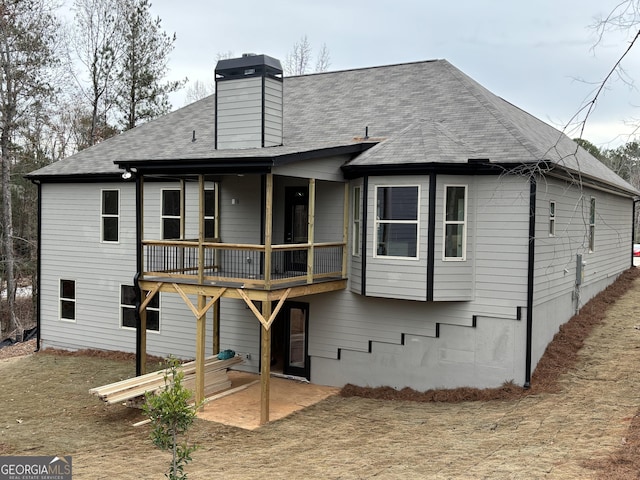 5544 Whispering Swan Ct, Douglasville, GA 30135 - rear view of property featuring a chimney and roof with shingles
