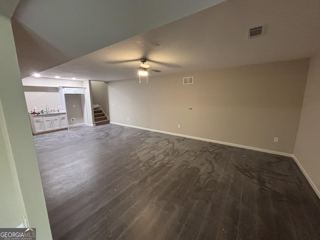 5544 Whispering Swan Ct, Douglasville, GA 30135 - unfurnished living room featuring dark wood finished floors, baseboards, stairs, and a ceiling fan