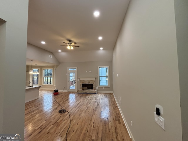 5544 Whispering Swan Ct, Douglasville, GA 30135 - unfurnished living room featuring ceiling fan, wood finished floors, recessed lighting, baseboards, and lofted ceiling