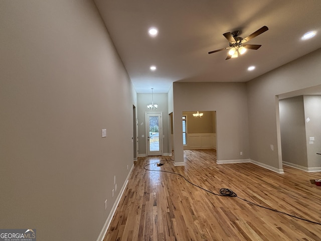 5544 Whispering Swan Ct, Douglasville, GA 30135 - unfurnished living room with a chandelier, light wood-style floors, recessed lighting, a ceiling fan, and baseboards