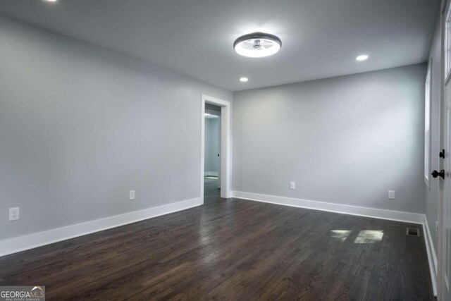 empty room featuring dark wood-type flooring