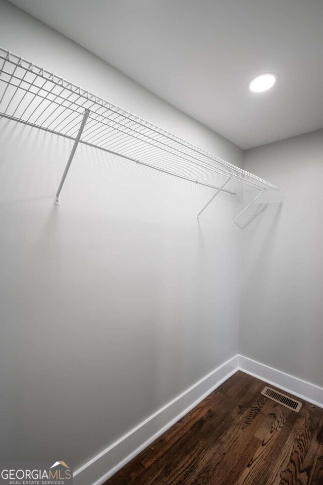 walk in closet with wood-type flooring