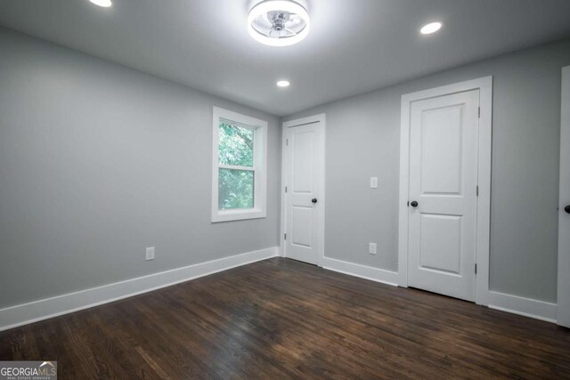 unfurnished bedroom with dark hardwood / wood-style floors