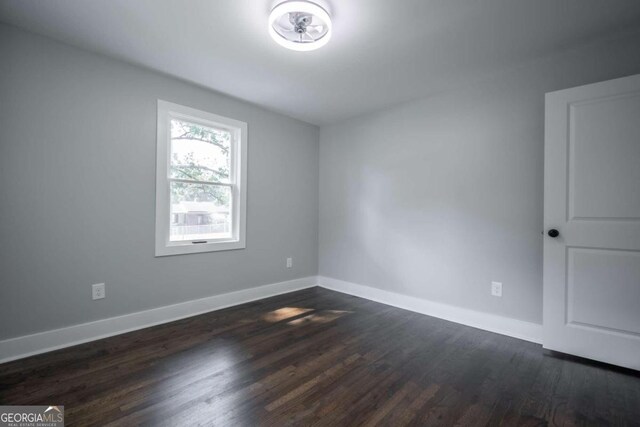 unfurnished room featuring dark hardwood / wood-style flooring