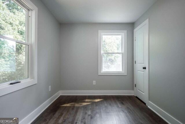 unfurnished room featuring dark hardwood / wood-style floors