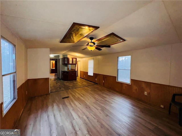 unfurnished living room featuring ceiling fan and hardwood / wood-style flooring