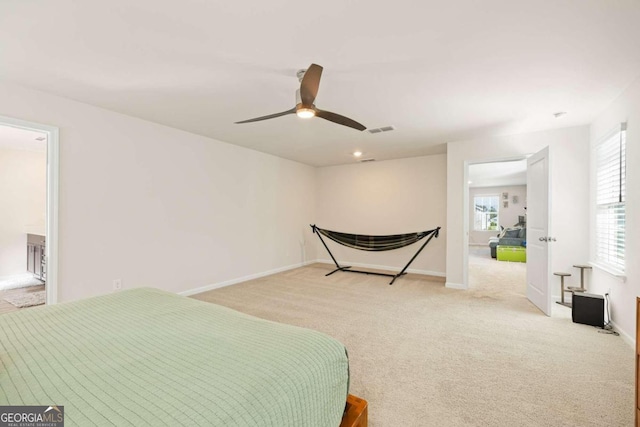 bedroom with ceiling fan and light carpet