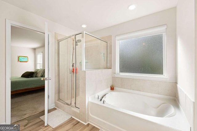 bathroom with hardwood / wood-style flooring and plus walk in shower