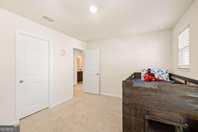 bedroom featuring light colored carpet