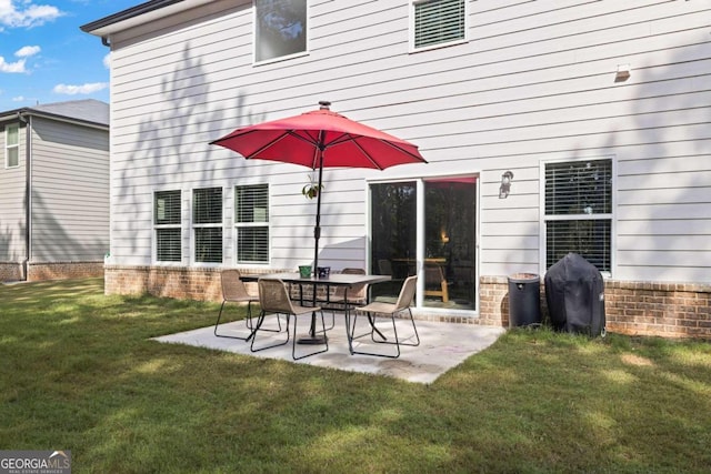 rear view of house with a yard and a patio area