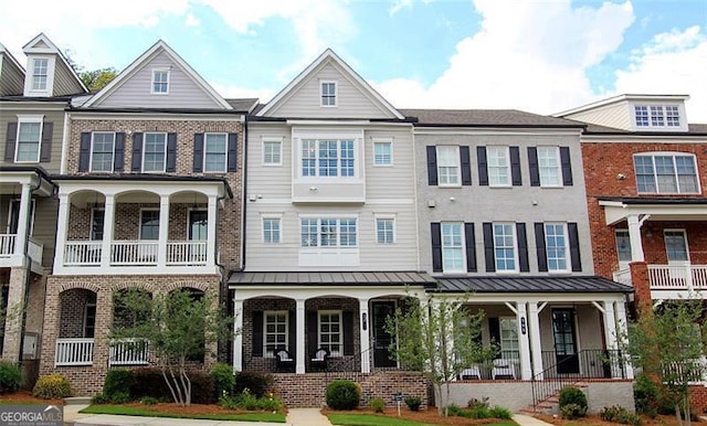 multi unit property with a balcony and covered porch