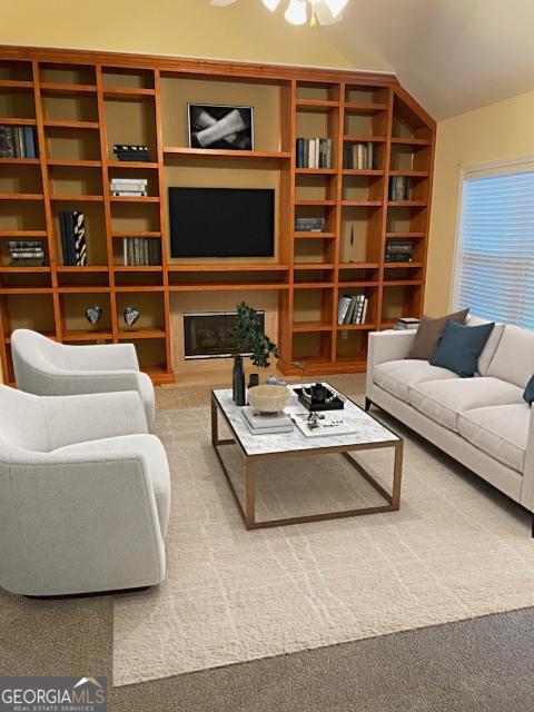 carpeted living room featuring ceiling fan and vaulted ceiling