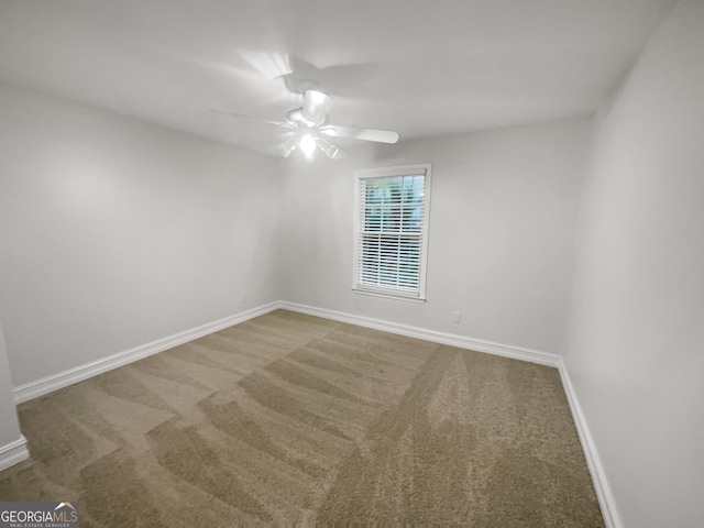 unfurnished room with ceiling fan and carpet floors