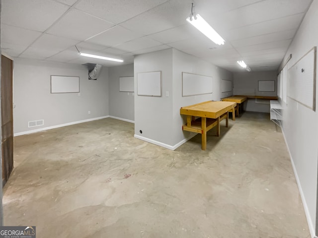 basement with a paneled ceiling