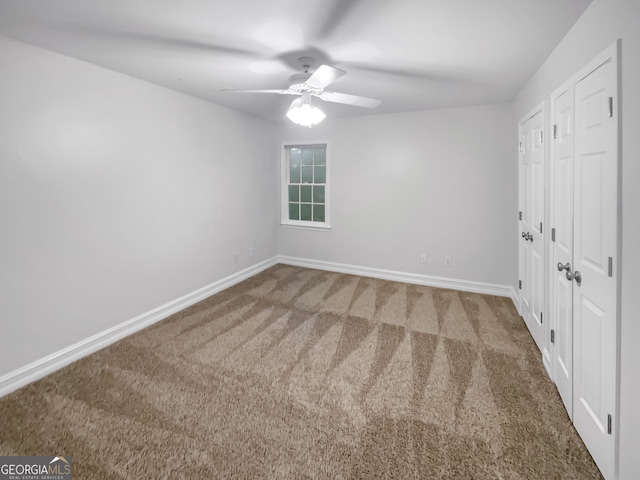 unfurnished bedroom with ceiling fan and carpet floors