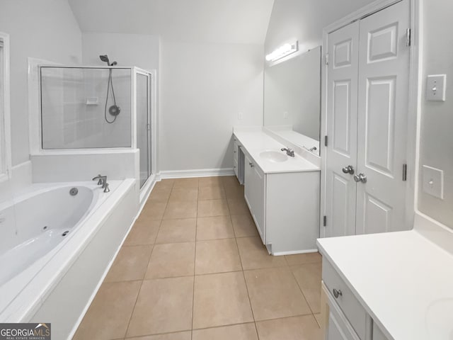 bathroom with independent shower and bath, vanity, vaulted ceiling, and tile patterned floors