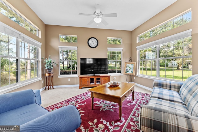 living room with ceiling fan and light tile patterned flooring