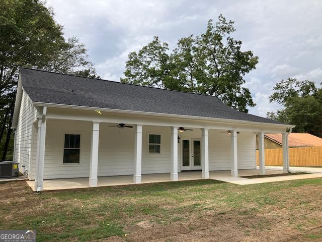 rear view of house featuring central AC, a patio area, a lawn, and ceiling fan