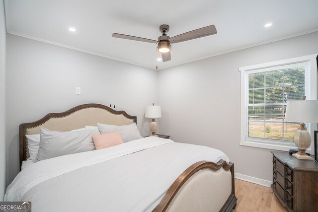 bedroom featuring ceiling fan, light hardwood / wood-style floors, and ornamental molding