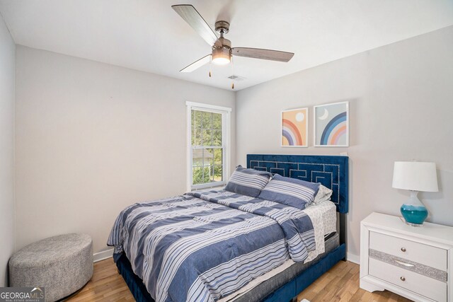 bedroom with ceiling fan and light hardwood / wood-style flooring