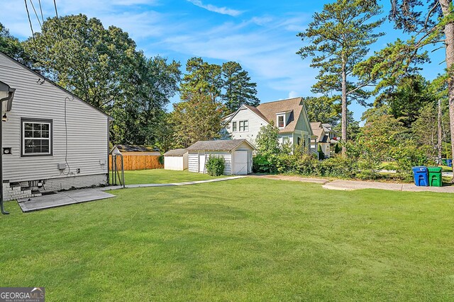 view of yard featuring an outbuilding and a patio